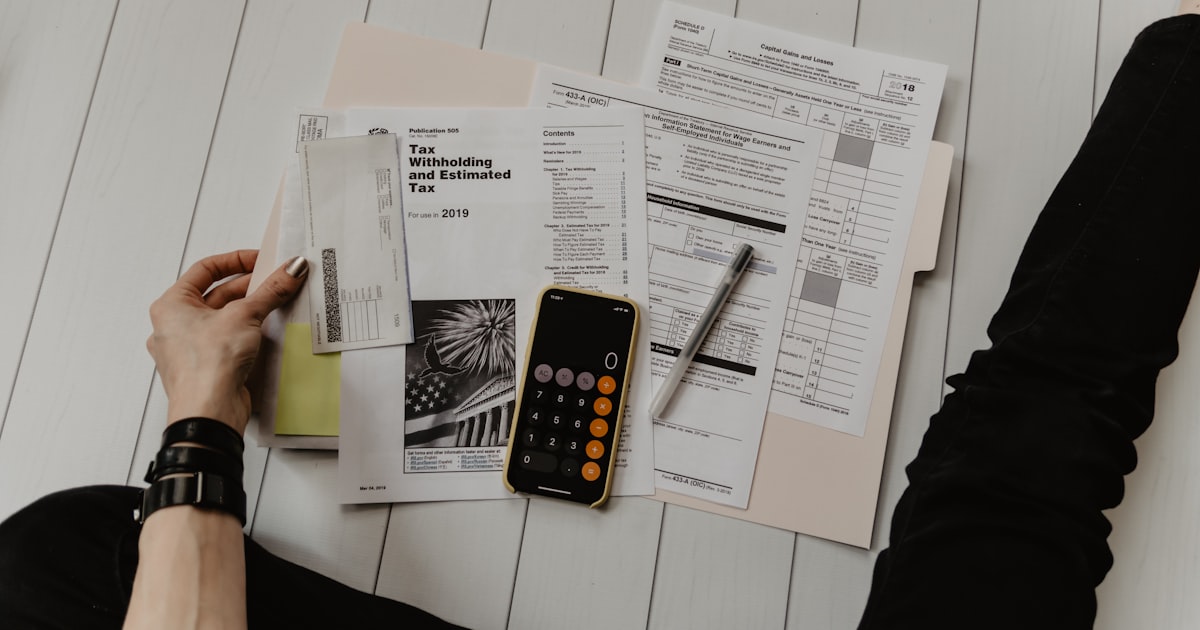 Contractor reviewing expense receipts at a desk